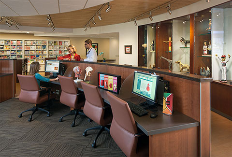 Visitors and providers use computers and converse with one another inside the Don and Cathy Jacobs Health Education Center. 