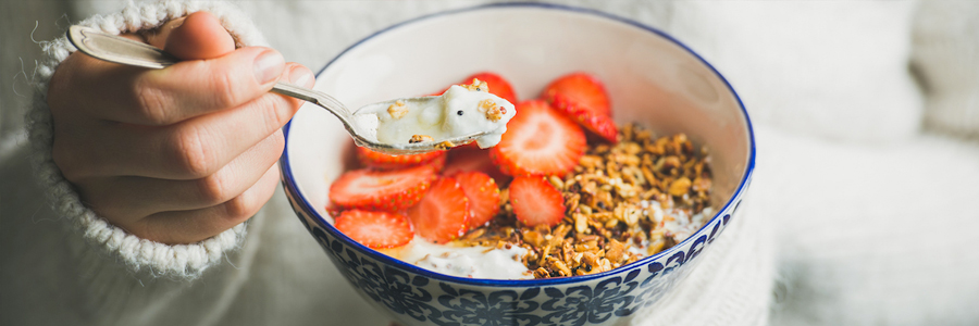 A bowl of granola with strawberries