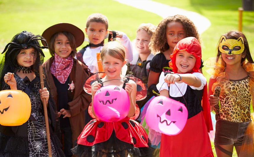 A group of children are dressed in costumes for Halloween.