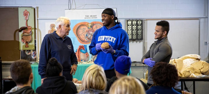 Don Frazier, director of the UK Outreach Center, works with students from a kinesiology class at UK.