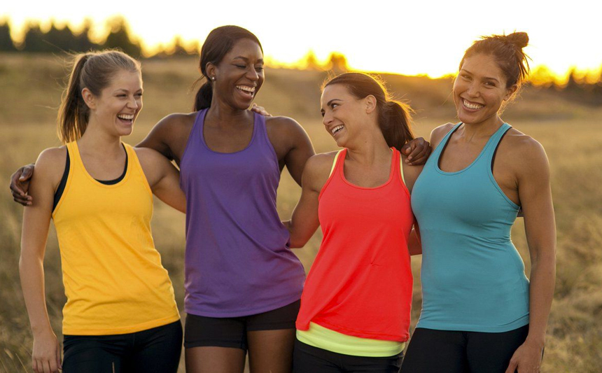 Four young women dressed in workout clothes.