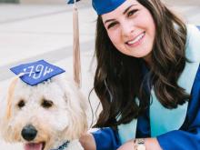 Allison Couri with her service dog at graduation.