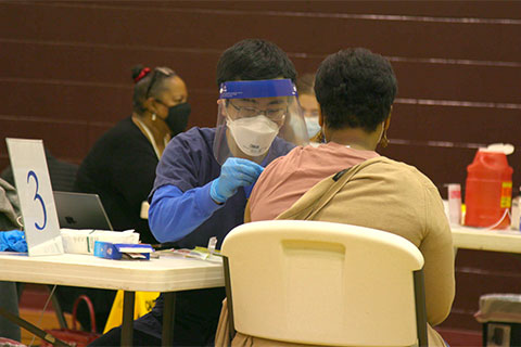 A nurse administers a COVID-19 vaccine at the Bracktown mobile outreach event. 