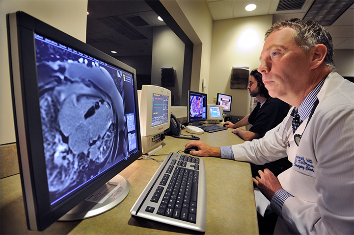Doctor looking at cardiac imaging scans