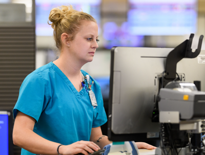 A nurse enters a patient's health information into a computerized system.