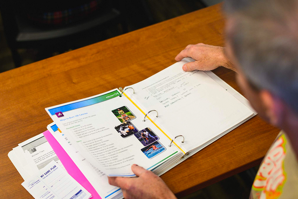 Fred Wohlstein looks through a binder of information from his diabetes education class.