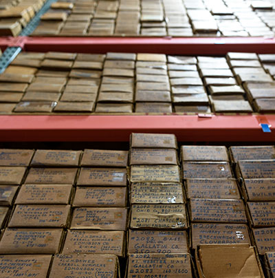 Geological core samples warehoused in rows.