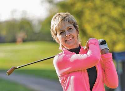Geri McDowell swings a golf club.