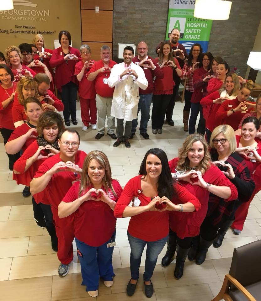 Employees of Georgetown Community Hospital pose for a photo with their hands shaped into hearts.