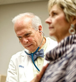 Lowell Anthony listens to Geri's heart during a followup visit. Read her story »