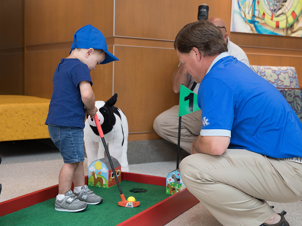 A young patient putts.