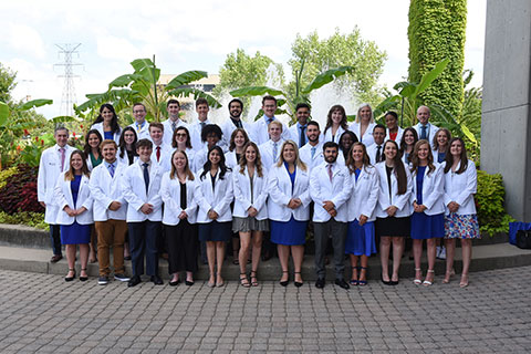 New students at the UK College of Medicine's Bowling Green campus pose outdoors for a group photograph following their white coat ceremony. 