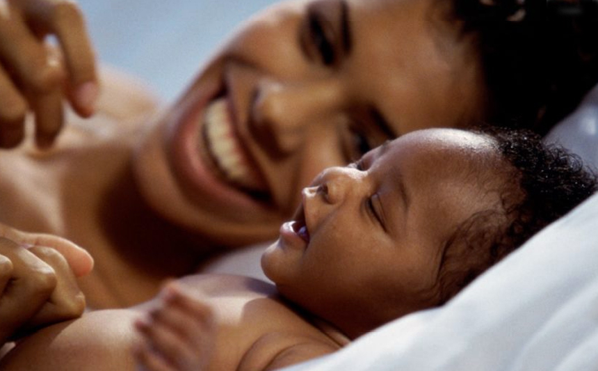 Mother smiling at infant