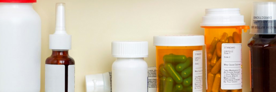 A row of medications is shown in a medicine cabinet.