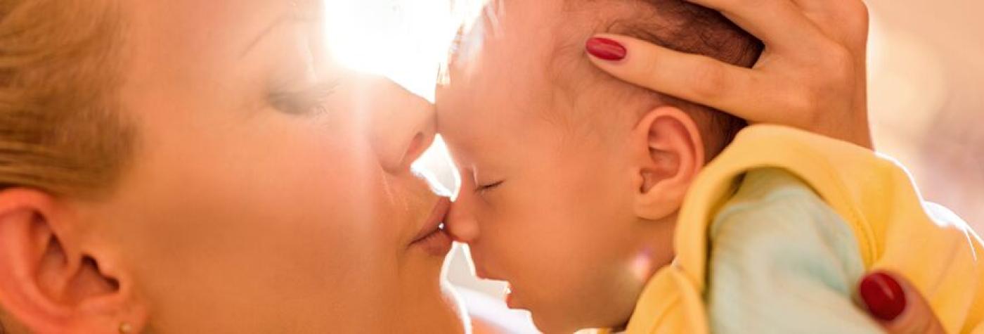 mom kissing baby's nose