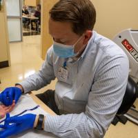 Matthew Rose of the UK HealthCare Hand Center works with Levi Yoder.