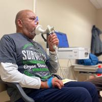 Raymond Cloud measures his breathing using a spirometer during a visit to the UK Transplant Clinic.