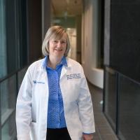 Dr. Emma Birks, a cardiologist with UK HealthCare, stands in a hallway.