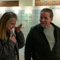 Deborah, left, wipes tears from her eye while Ron looks at her after they visit the Gift of Life wall at UK HealthCare.