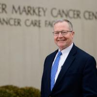 Dr. Timothy Mullett, a lung cancer specialist at UK HealthCare, stands in front of the Markey Cancer Center building.