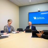 Dr. Mullett and his colleagues smile during a meeting together.