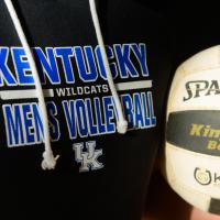 Close up of Gil's Kentucky Wildcats Men's Volleyball sweatshirt and Spalding volleyball.