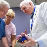 Dr. Lowell Anthony, a specialist at Markey, explains a recent scan to Joe and Cathy.