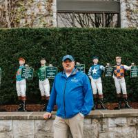 A photo of Matt posing for the camera in front of a display at Keeneland.