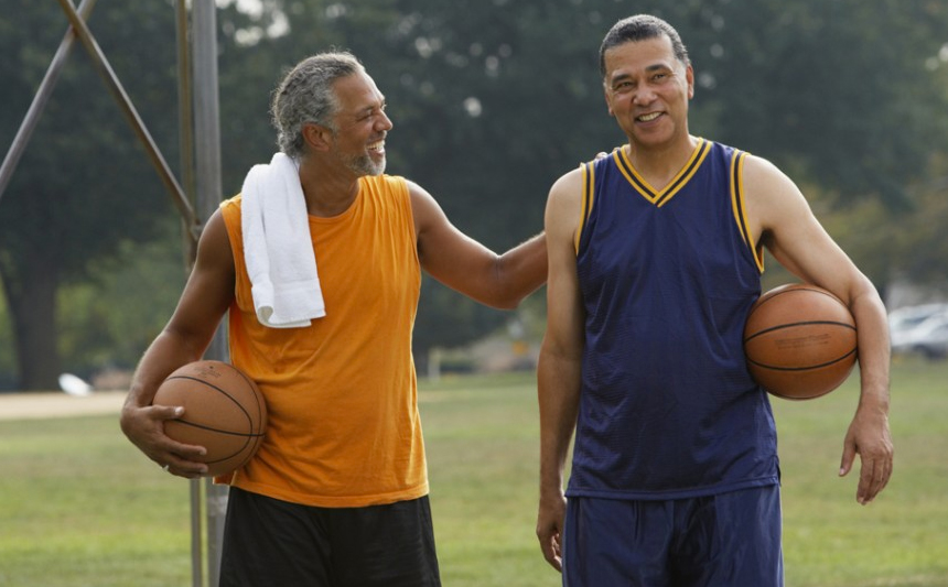 Two men holding basketballs.